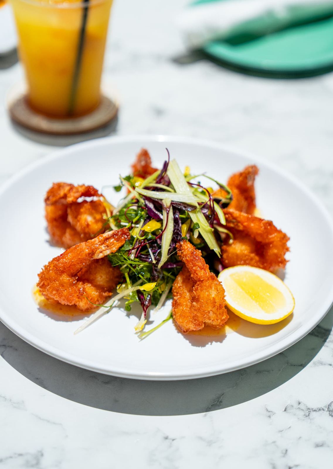Coastal coconut shrimp with greens and lemon